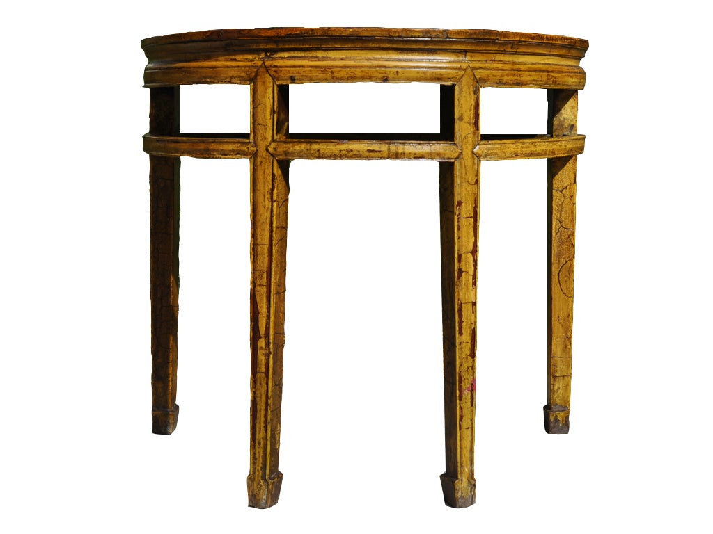 Originally covered in ox blood lacquer, this Chinese half round table was painted mustard yellow in the 1960s.  The original dark finish is still visible in abraded areas, making for a two-toned basket.