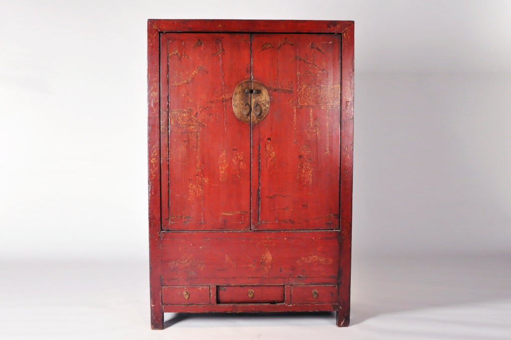 This Ming-style clothing cabinet features an elegant landscape painting on its front.  Though faded, the outlines of mountains, trees, grand houses and various figures are still visible.   Much gold outlining is still present.  The red lacquer