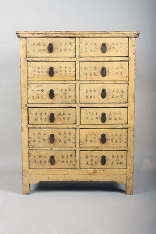 Coated in a beautiful golden-yellow lacquer, each of the 12 drawers is labeled with elegant calligraphy indicating the contents of each, helping keep the herbs and spices organized.