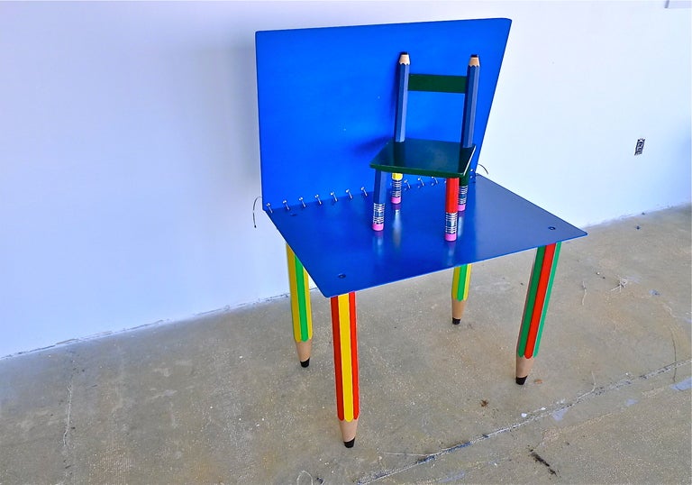 Whimsical table in form of a spiral notebook with flip-open top and stylized wooden pencils as legs.  Includes this chair with pencil erasers as feet. Pierre Sala, France (1948 - 1989).  Between the covers of the notebook can be placed sheets of