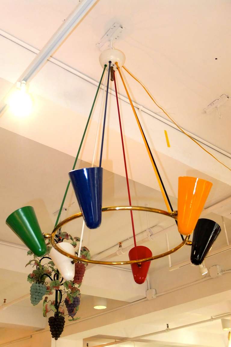 1950's Italian suspension chandelier consisting of 6 colorfully enameled aluminum cones attached by brass swivel joints to a brass hoop ring which is suspended by 6 colorfully painted metal rods.

Cones are independently adjustable and can be