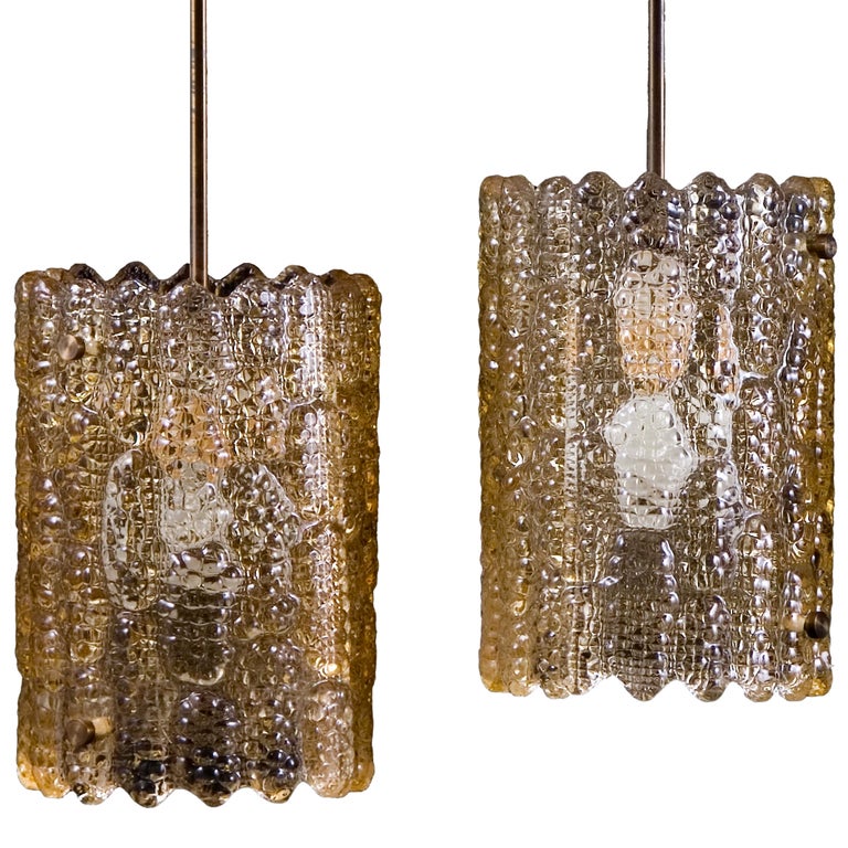 Pair of amber tinted pendant lights by Carl Fagerlund for Orrefors with brass fittings.

Brass rods can be extended or shortened to your requirements.

Price listed is for the pair. 