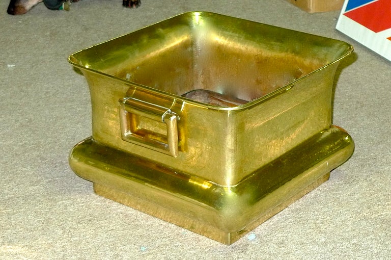 This square shaped brass planter with double handles has a slight orientalist vibe reminiscent of Jame's Mont.