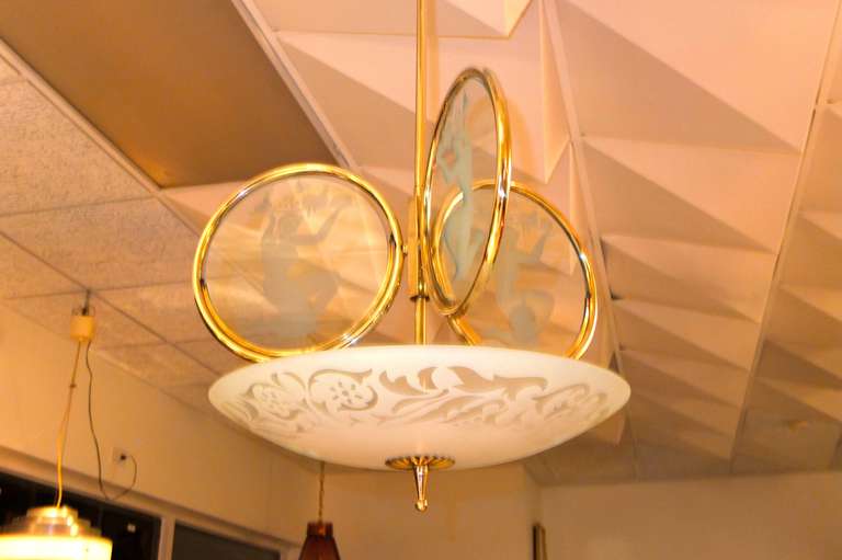 1940's Italian Chandelier in the manner of Pietro Chiesa for Fontana Arte with a half-dome reflector in etched glass abobe which are three brass rings with round glass etched with neoclassical nude female figures holding banquet trays, rendered in