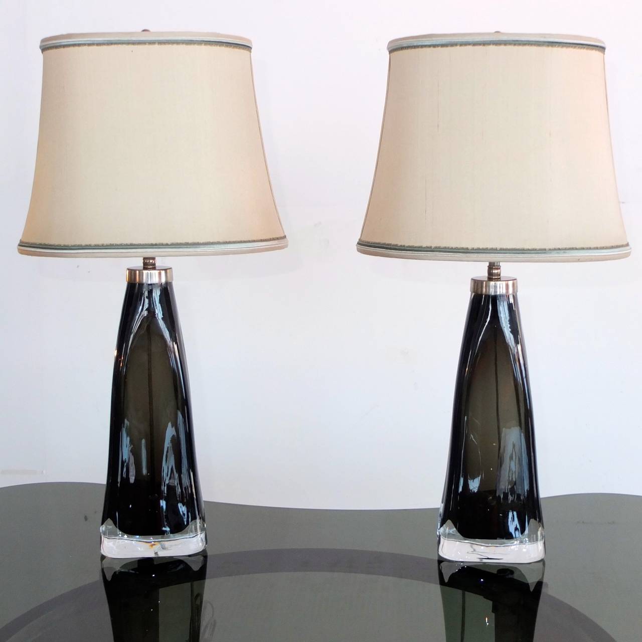 Beautiful pair of smoked cased glass table lamps by Carl Fagerlund for Orrefors, Sweden, circa 1960's with nickel fittings. Totally rewired and re-lamped with high quality double sockets with pull chains. Adjustable lampshade risers. Glass is