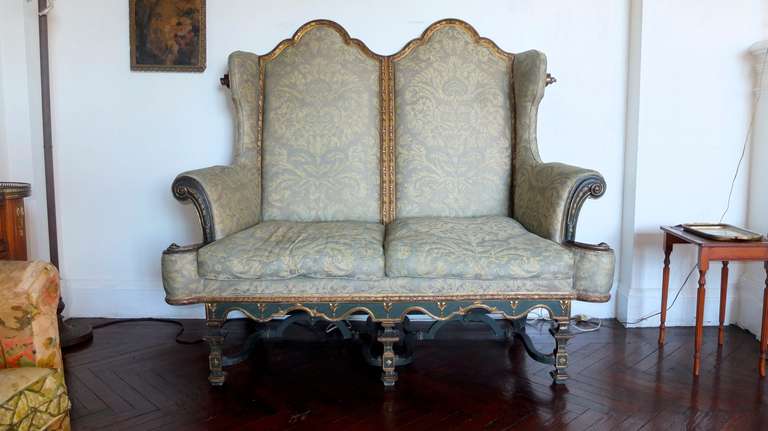 Antique Circa 1910 reproduction of the Duke of Leeds double chair from Hornby Castle.
William & Mary form parcel gilt and dark green polychromed double-chair settee covered in vintage pale green Fortuny De Medici cotton with metallic overlay.