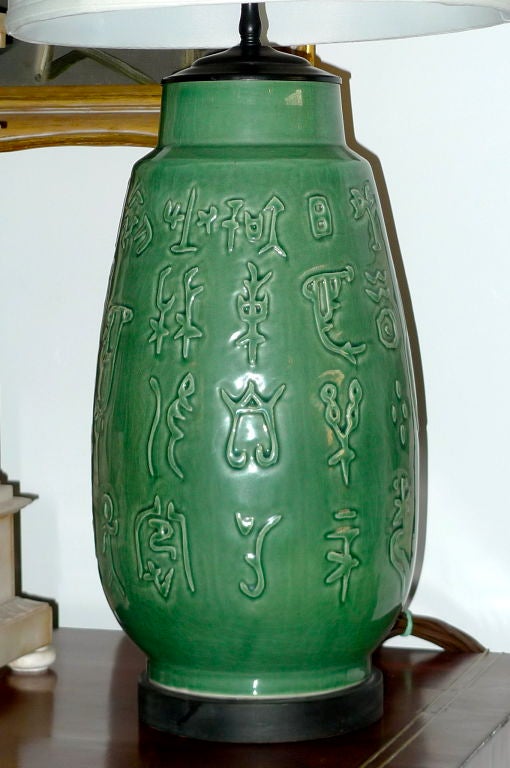 Large single table lamp in jade green ceramic with Asian characters and ebony base.