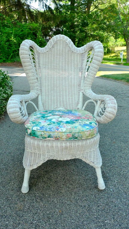 An old wicker art deco wing chair for the boudoir with solid skirt and fiddelhead embellishments. Lose seat cushion with independent back cushion. Possibly by Lexington.<br />
<br />
I have several pieces of old wicker (some shown including a
