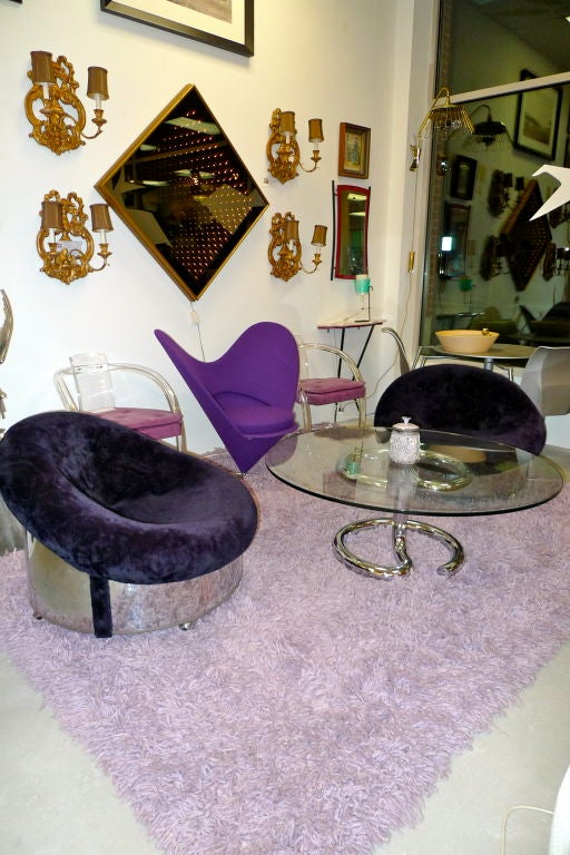 Attributed to Adrian Pearsall of Craft Associated these polished steel drum or barrel or chairs on casters are upholstered in their original sapphire blue crushed velvet.  Incredibly plush and gorgeous