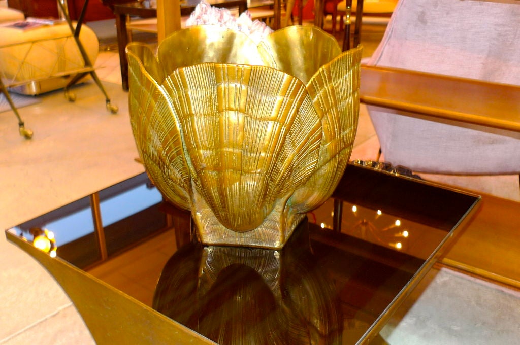 Hand made sculptural cache pot jardiniere in seashell form made of solid brass. Weighs nearly 25 pounds. Glamorous high-quality Hollywood Regency item.