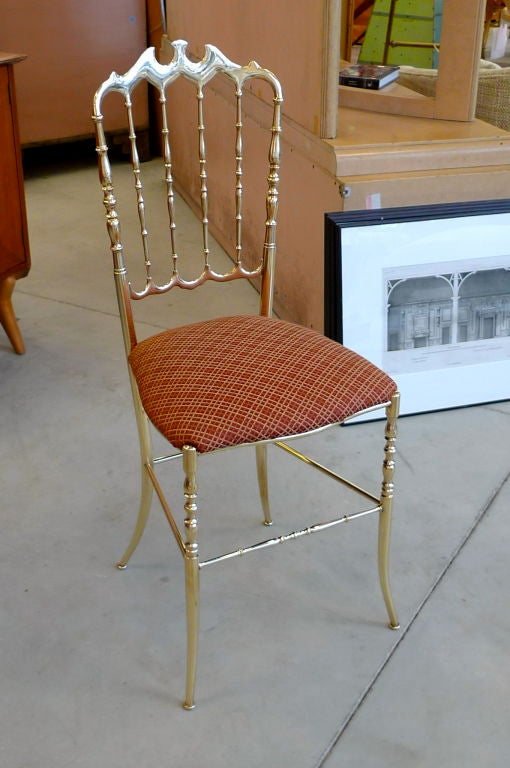 This is the gold standard in chic! Solid polished brass Chiavari chair with dainty splay feet.  Designed by Giuseppe Gaetano Descalzi and produced since the early 19th century in the Ligurian town of Chiavari.<br />
<br />
Perfect for a ladies