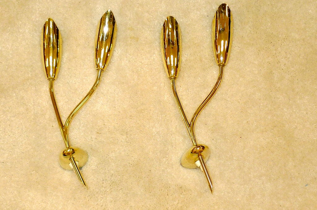 Pair of 1950's Italian brass double-stem sconces, possibly ny Fontana Arte.  Note the similarity with the brass elements of the Dahlia sconces in image 8.<br />
I realized after having taken these photos and installing them in the NYDC that these