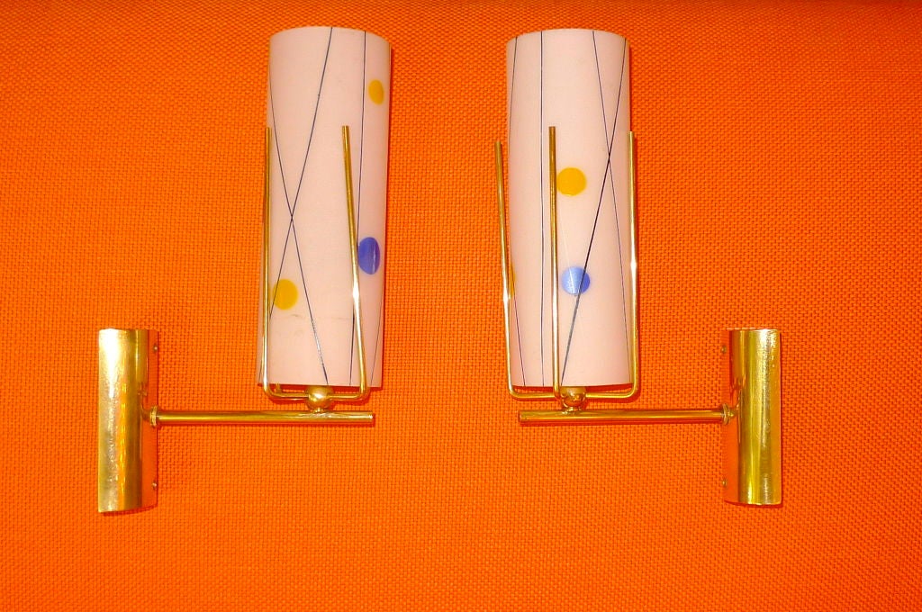 These are so fun and simple.  Brass mounts holding colorfully serigraphed opaline glass tube shades with an Eames style design.<br />
<br />
Rewired.