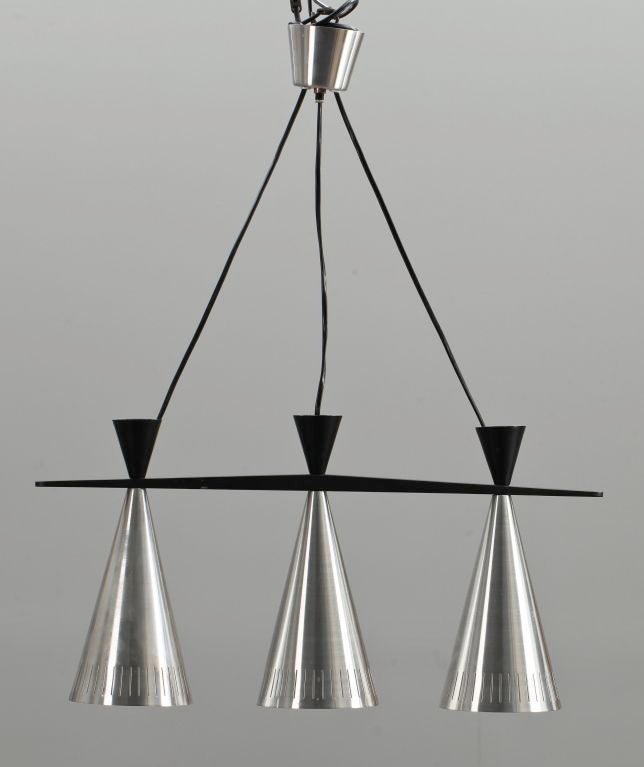 SATURDAY SALE (2/2019)


A pair of 1950's linear pendant light fixtures from Sweden with three spun aluminum perforated cones with matte black enameled diabolo tail cones on a tapering wedge of ebonized wood.  Lovely original canopies. Adjustable