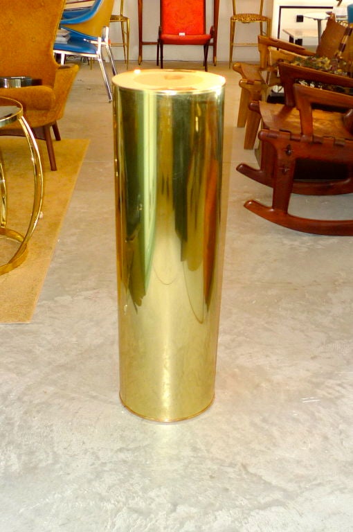 A round brass pedestal display column by Curtis Jere, signed and dated 1986.