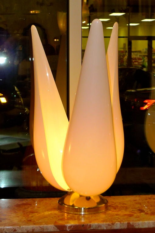 Incredibly decorative table lamps in the form of a tulip, one with three, the other with four large organic pale pink acrylic petals surrounding an internal well of light. One on a brass base, the other on a black base.  In the manner of Roger