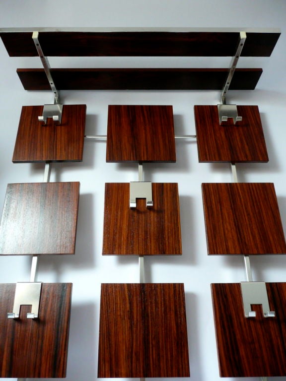 Handsome coat rack consisting of aluminum structure with 12 rectangular pieces of rosewood veneered blocks. The coat rack has a top shelf made of two aluminum brackets with two narrow wooden planks finished with rosewood laminate and decorated at