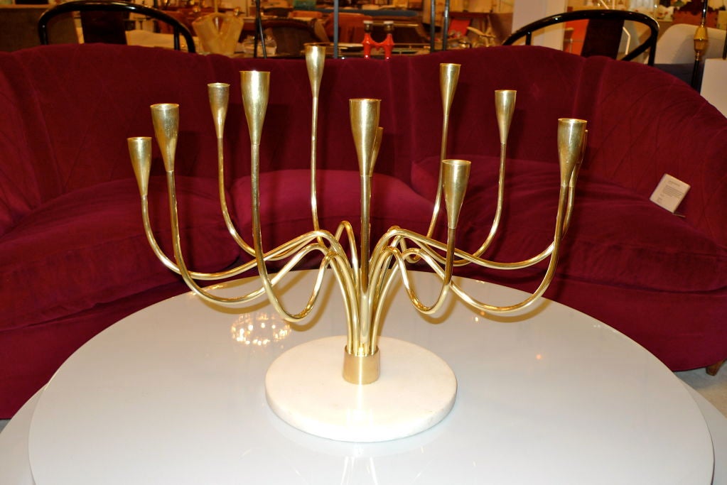 Twelve branch brass candelabrum candle holder on white marble base by Stilnovo, Italy, circa 1960.