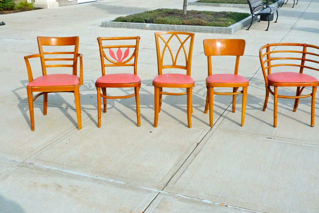 Jolly and merry set of nine cafe chairs by Kohn Mundus of Austria, each a different model with same original melon color vinyl seat cover. Sold as a complete set.<br />
<br />
Jacob & Josef Kohn produced bentwood chairs in the 19th and early 20th