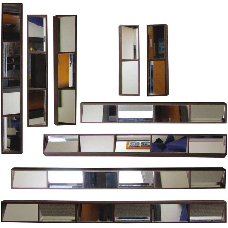 Set of 9 slim box framed mirrors; four sizes.
the mirrored glass itself divided and directed on alternating planes to give a brutalist effect similar to Neal Small's Slopes mirrors. 
Unmarked but probably produced by Turner Arts who produced groovy
