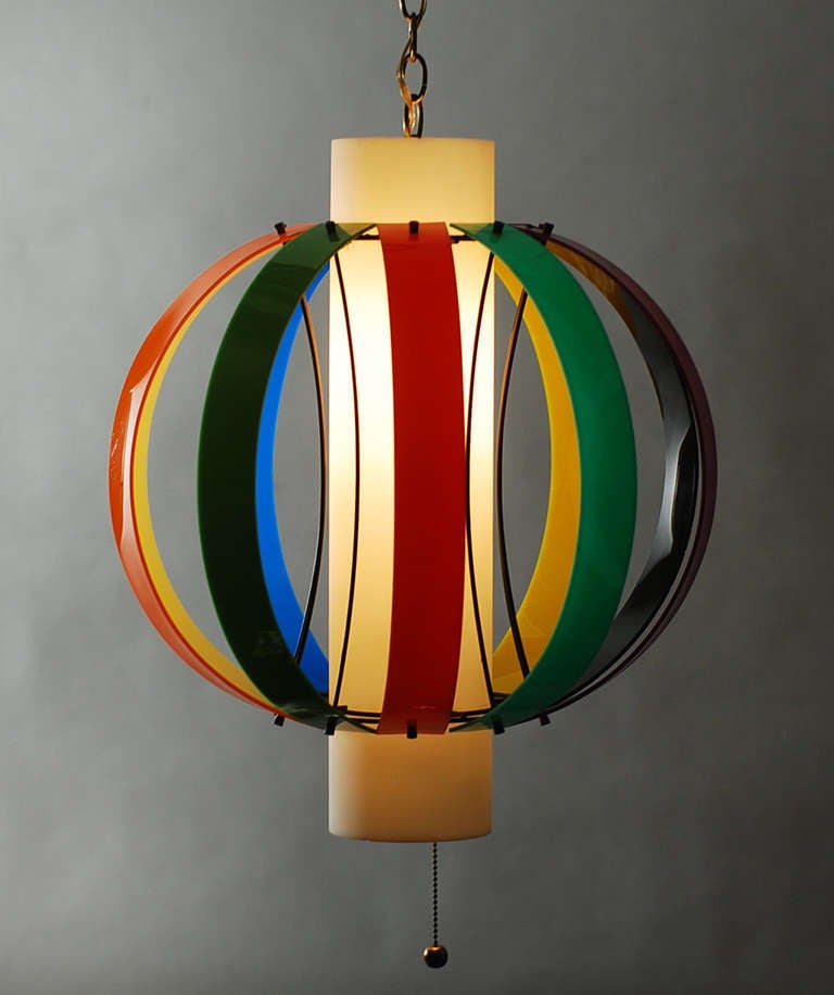 1950s vintage pendant produced by Lightolier based upon a design by Angelo Lelli for Arredoluce.

This pendant had originally had a brass drop rod but had been converted to a swag pendant with brass chain. We returned it to having a 3/8