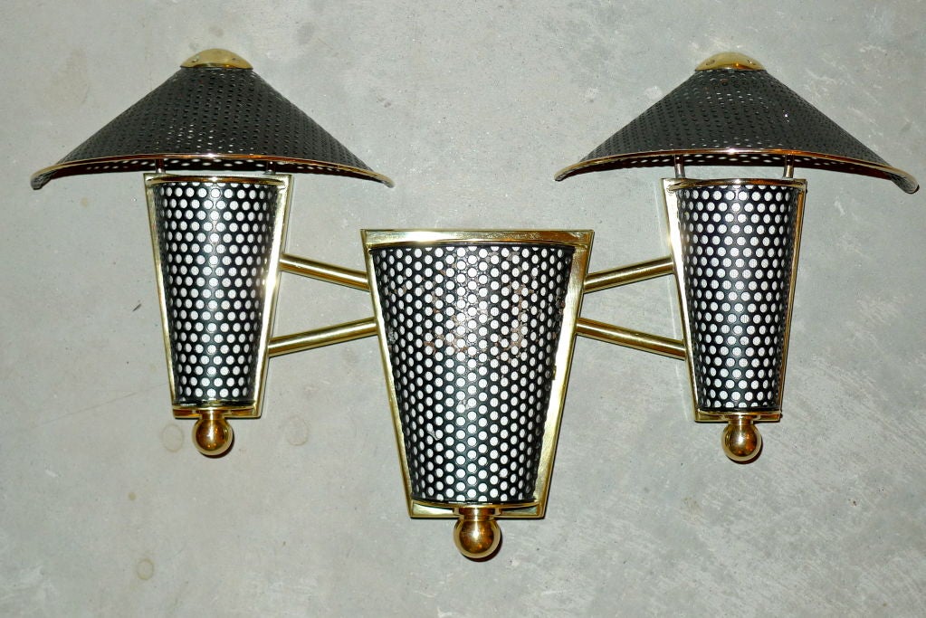 Unusual 3 light wall lamp in brass and enameled perforated metal attributed to Jacques Biny.  <br />
<br />
See companion wall lights available separately.