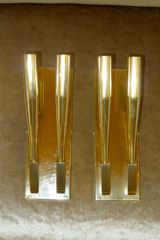 Hefty machined brass double-barrel brass sconces attributed to Gio Ponti.  
Price shown is for a pair but we have a third sconce available.  
Please note that in photos 11-20 the third sconce has been freshly polished while the other two show a