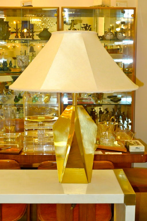 Sculptural brass table lamp of geometric form with diamond and harlequin planes.  Attributed to Gaetano Sciolari.<br />
<br />
Total height with harp as shown 28 inches.  18 inches high to just below where socket starts.  Base alone is 15 inches