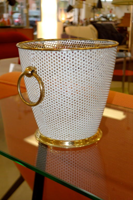 Charming ice pail or wine chiller after Mathieu Mategot mate of white enameled perforated metal with brass banding, base and rings with original glass liner.