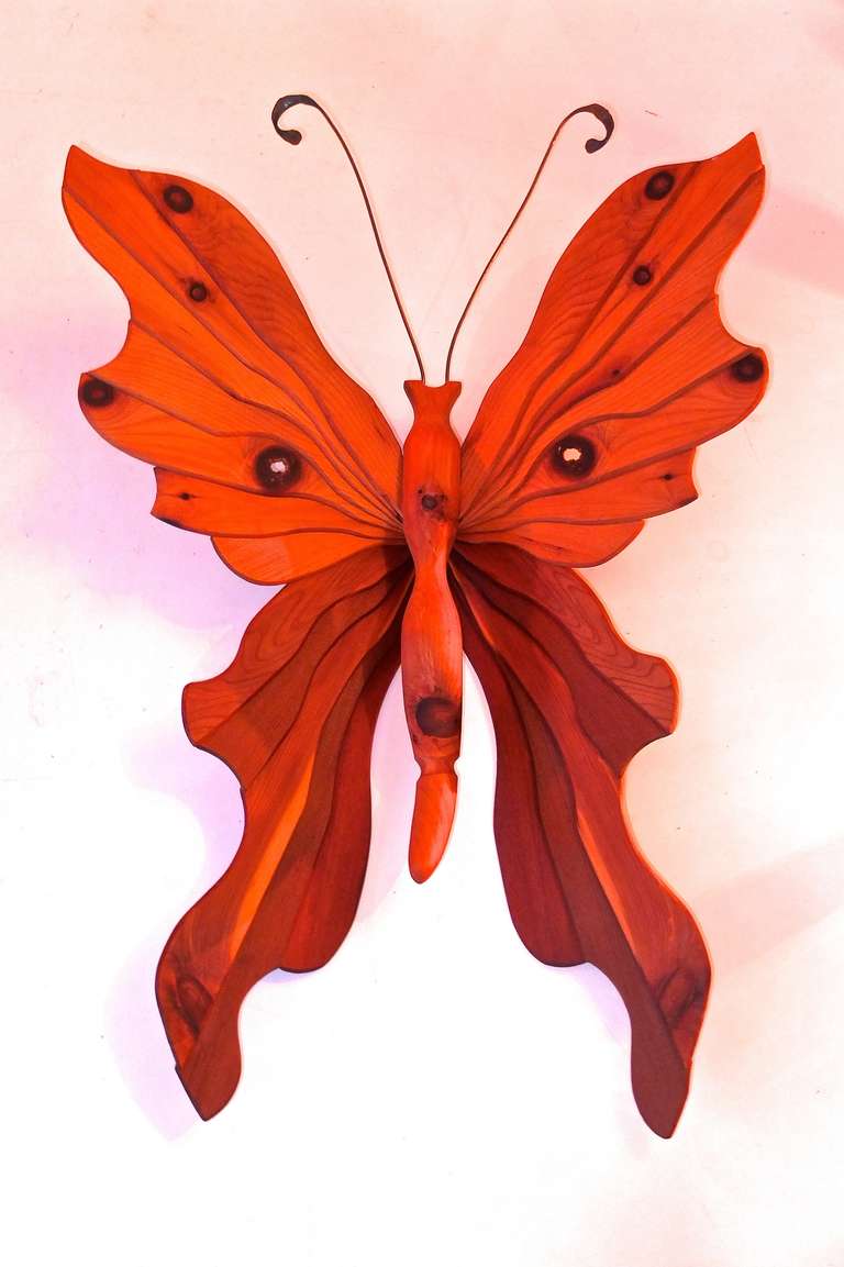 Enchanting sculptural wood craft butterfly artfully created with select slats of well-chosen wood (cedar and pine) so the knots appear as the spots on the butterfly wings. Has aged with a caramel patina. The antennae are hand-hammered copper wire.
