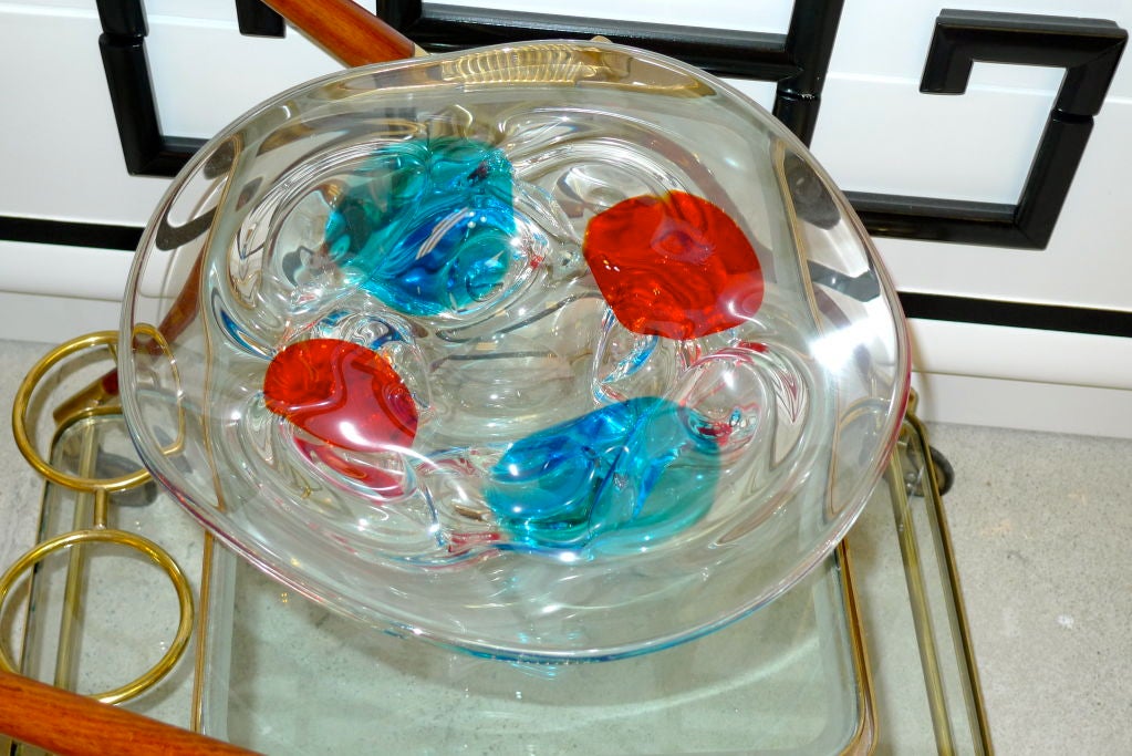 A large Murano glass bowl, unsigned, attributed to Fulvio Bianconi for Cenedese.  Heavy clear glass with blue and red inclusions.