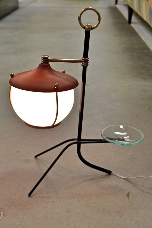 Charming stick figure cartoon of a lamp with beautiful solid brass hardware against black enameled frame, opaque white globe and tomato/brick red enameled aluminum reflector. This is undoubtedly a 1950's homage to the student lanterns of the