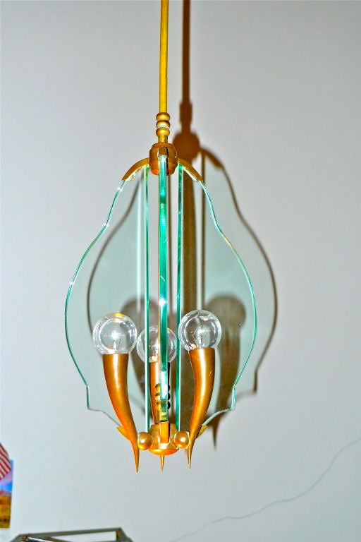 A late 1940's early 1950's hanging pendant chandelier in the style Gio Ponti.  Tri-form with three bronze stylized horns and cartouche edge glass. Unmarked.