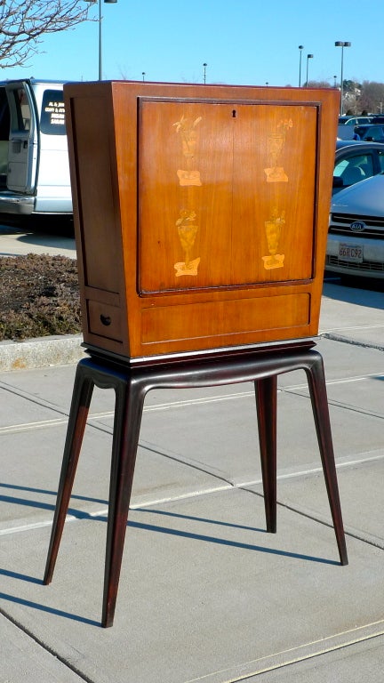 Late 1940's/early 1950's Italian dry bar, martini cabinet with inlaid fruit wood marquetry, tapering rectangular top and drop front attributed to Osvaldo Borsani.. Inside back has been silver leafed. Illuminated. Side drawer.