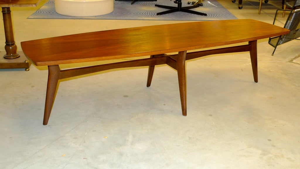 Late 1950's blunt edge floating surfboard shaped cocktail table by Mersman with stylishly angular legs in the manner of Vladimir Kagan, Gio Ponti and Ico Parisi.