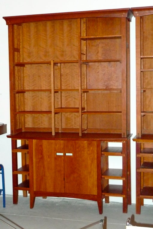 New York architect, Robert Thorpe, designed and built book cases in the arts & crafts style.  Solid cherry. Each unit is two pieces and each piece can also be used independently....lower case as console/buffet/server;  Upper shelves units can stand