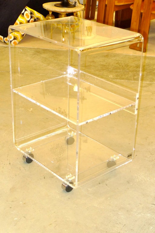 Quality fabricated waterfall edge lucite rolling cart by AKKO Acrylic Products of Lawrence, MA. Great for tv, barware, computer, cosmetics, etc.  On chromed casters.  Middle shelf had a 2 inch gallery.
