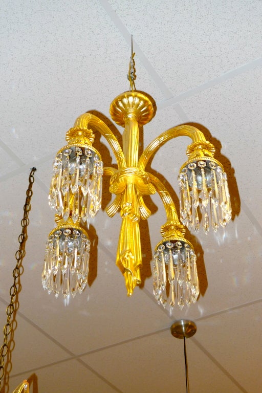 

Elegant gilt cast bronze four arm French chandelier with cut crystal pendants.