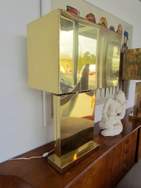 An elusive matching pair of monumental brass table lamps with brass box shades of architectural form, signed C. Jere.