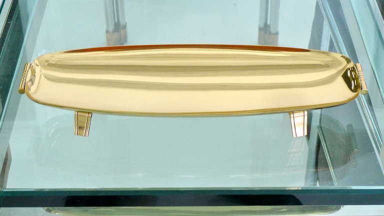 Tommi Parzinger for Dorlyn Silversmiths long brass tray with detailed handles and four feet.  Professionally polished and re-lacquered.