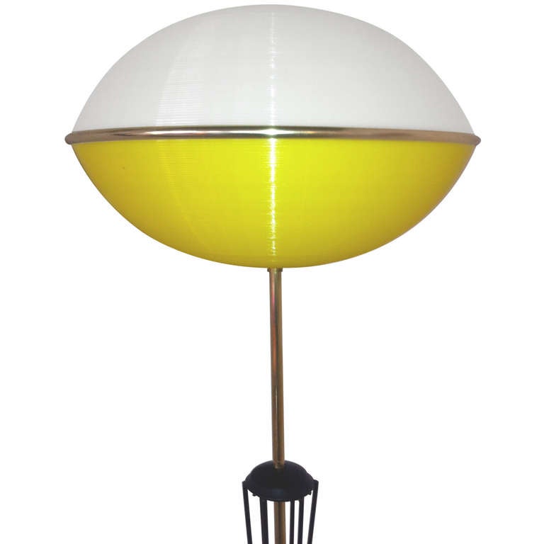 What a presence!  Majestic 1950's French floor lamp consisting of a stalk of black enameled brass tubing stretching upwards nearly 5 feet to a long brass skinny neck and an amusing extra-terrestial-like brain made of yellow and white ribbed perspex.