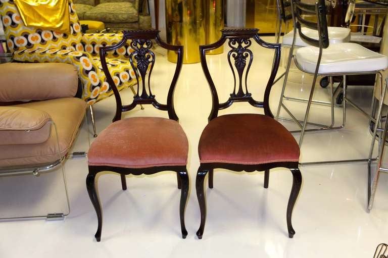 Pair of lovely little carved mahogany shield-back salon chairs with elements of both Georgian and Queen Ann styles.  

Very sweet and charming.

Perfect extra seating when entertaining or for use with a ladies writing table.