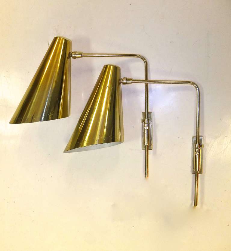 Pair of solid brass and brass plated aluminum adjustable wall lamps in the style of Finnish designer Paavo Tynell.

These are perfect for bedside reading lamps and even could be mounted to a headboard.

They come corded for plug-in but the solid