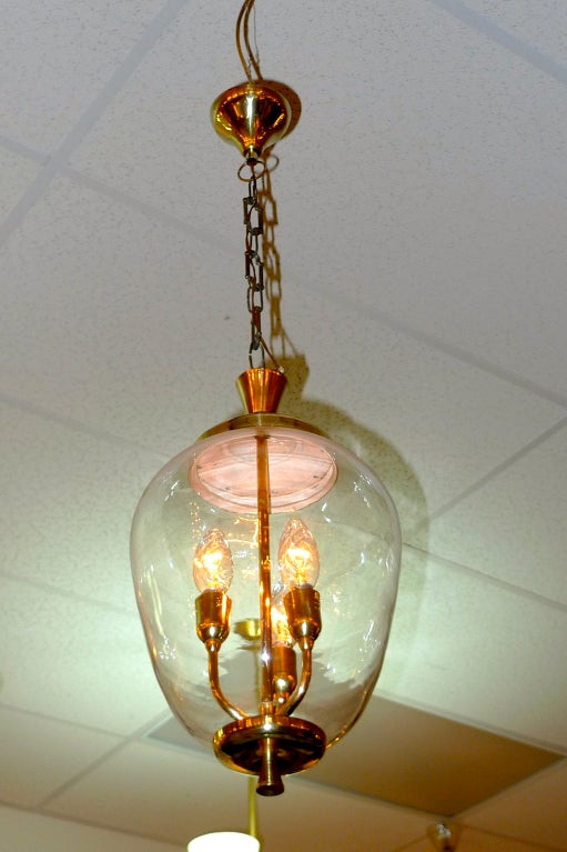 Timeless mid-century Italian hallway pendant lantern with three candle bulb stem inside a hand blown clear glass 'pickle jar' oval bell.  Timeless and elegant.