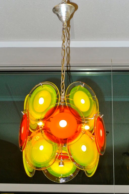 True beauty never fades which explains why this 1960's murano glass disc chandelier by Vistosi glows with happiness and fun.  

Sometimes imitated, never duplicated.