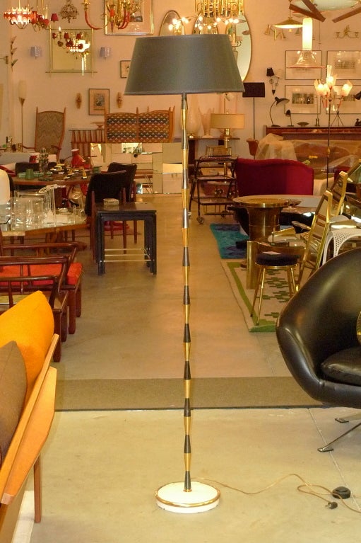 Extraordinary design of this 1950's Italian (probably) floor lamp made from precision machine turned solid brass cones, half have which have been anodized with a gunmetal finish, giving the shaft of this floor lamp a diamond patterned