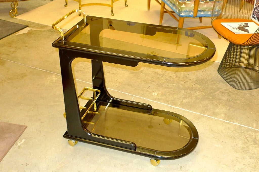 This sleek and dynamic bar cart is clearly the scion of the best designed carts of the previous generation (Ico Parisi, Cesari Lacca, Carlo di Carli, et al) and certainly does its forebears proud!  Aerodynamic and modern yet with a nod to tradition.