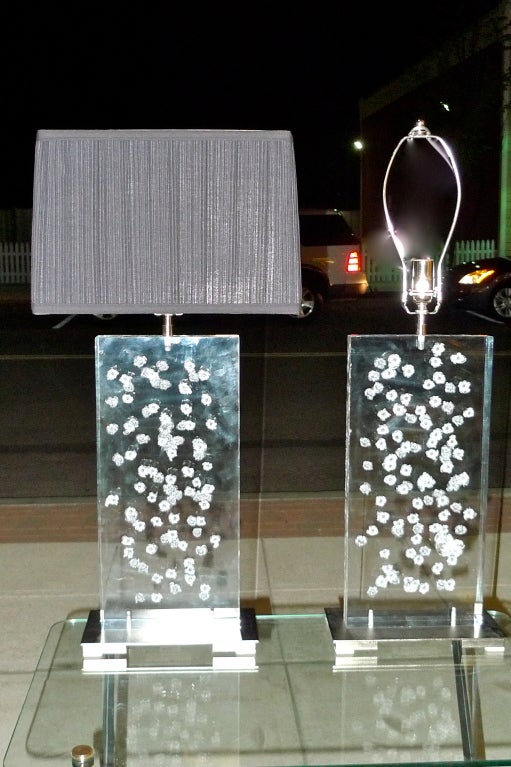 Pair of large scale table lamps made from one inch thick acrylic slabs cut from an old security window salvaged from a bank undergoing renovations.  Bases made from salvaged polished steel.  (Shade for display only) 

Newly wired.  All parts UL