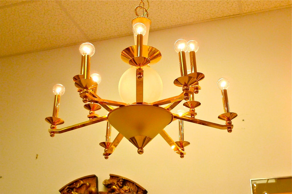 A large scale brass and frosted glass 12 arm chandelier 
