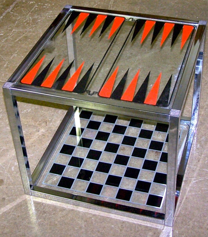 Vintage chromed cube form game table by Austin Enterprises with interchangeable glass game boards for backgammon, chess and checquers.  Comes with Bakelite game chips and dice and original box.